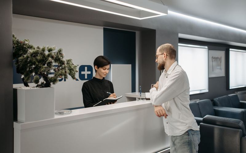 Patient checking in at a medical clinic front desk