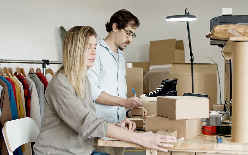 Small business owners packing orders in their workshop