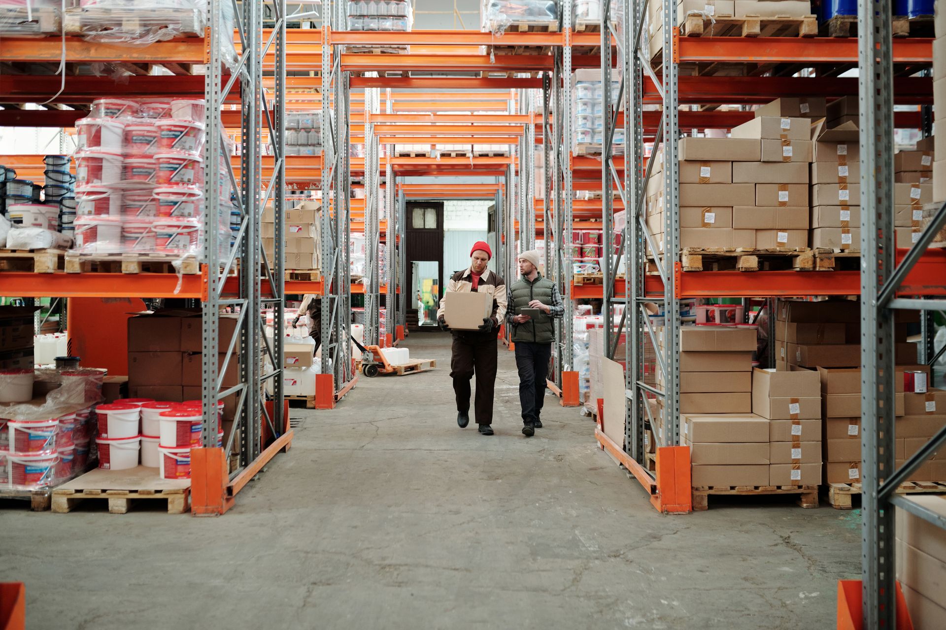 Modern distribution warehouse floor with industrial racking and workers